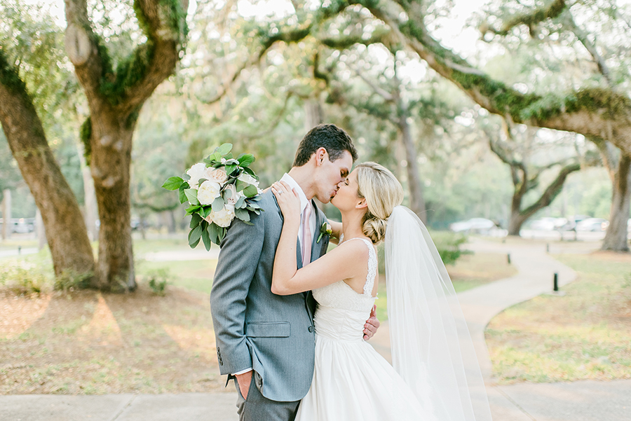 bride and groom kissing in front of jacksonville wedding venue