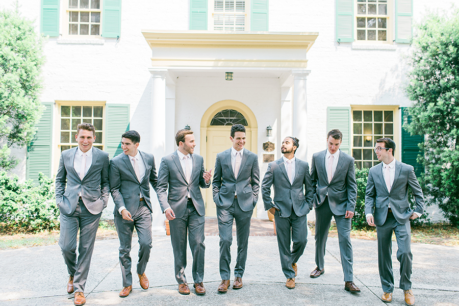 Groomsmen posing in front of Jacksonville wedding venue