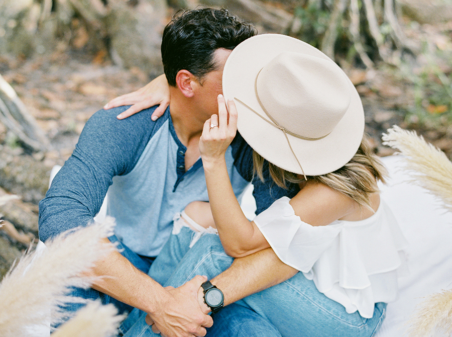 bride wearing wide brim hat in engagement session
