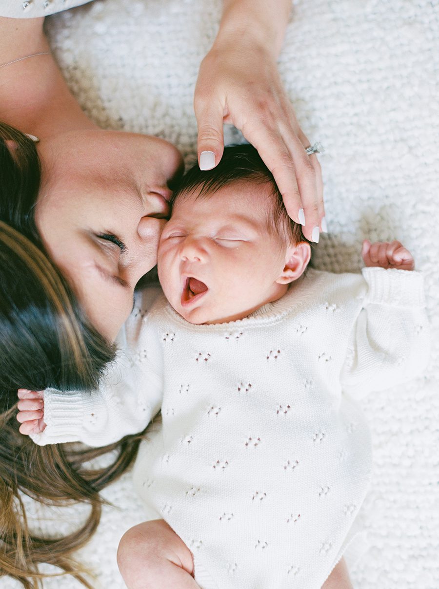 Mother kissing newborn